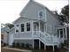 Charming home exterior showcasing the lower level of the house with stairs leading up to the front porch at 5153 Celtic Dr, North Charleston, SC 29405