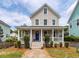 Charming two-story home with a welcoming front porch and well-manicured landscaping at 5153 Celtic Dr, North Charleston, SC 29405