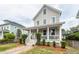 Charming two-story home featuring a welcoming front porch with classic white columns and a neatly landscaped yard at 5153 Celtic Dr, North Charleston, SC 29405