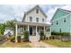 Charming two-story home featuring a welcoming front porch with classic white columns and a neatly landscaped yard at 5153 Celtic Dr, North Charleston, SC 29405