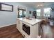 A large kitchen island with barstool seating complements white cabinets and stainless appliances at 5153 Celtic Dr, North Charleston, SC 29405