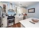 A light and airy kitchen features white cabinets, stainless steel appliances, and a stylish farmhouse sink at 5153 Celtic Dr, North Charleston, SC 29405
