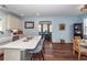 Open kitchen with a large island and bar seating, light-colored cabinets, and hardwood floors leading into the dining area at 5153 Celtic Dr, North Charleston, SC 29405