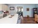 Open kitchen with a large island and bar seating, light-colored cabinets, and hardwood floors leading into the dining area at 5153 Celtic Dr, North Charleston, SC 29405