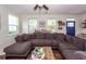 An expansive grey sectional couch is the focal point of this inviting living room with hardwood floors at 5153 Celtic Dr, North Charleston, SC 29405