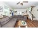 Open-concept living space features a plush sectional, hardwood floors, and easy access to a staircase at 5153 Celtic Dr, North Charleston, SC 29405