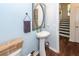 Stylish powder room with pedestal sink, decorative mirror, and blue walls, creating an inviting space at 5153 Celtic Dr, North Charleston, SC 29405