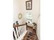Bright staircase featuring wood treads, white risers, a decorative mirror, and a window for natural light at 5153 Celtic Dr, North Charleston, SC 29405