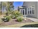 Beautiful backyard with a bird bath, greenery, mulch, and a screened in porch at 534 Four Seasons Blvd, Summerville, SC 29486