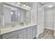 Bathroom with double vanity, modern mirrors and lighting, and walk-in closet access at 534 Four Seasons Blvd, Summerville, SC 29486
