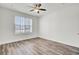 A sunlit room with wood floors, a ceiling fan, and a large window with shutter blinds at 534 Four Seasons Blvd, Summerville, SC 29486