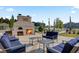 Cozy outdoor fireplace with comfortable seating area, perfect for gatherings and relaxation at 534 Four Seasons Blvd, Summerville, SC 29486