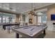 Inviting game room with billiards table, stylish lighting, and comfortable seating perfect for entertaining guests at 534 Four Seasons Blvd, Summerville, SC 29486