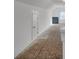Bright hallway with natural light and unfinished flooring for personalized customization and design at 534 Four Seasons Blvd, Summerville, SC 29486
