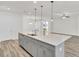 Modern kitchen island with quartz countertop and stainless steel appliances at 534 Four Seasons Blvd, Summerville, SC 29486