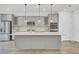 Stylish kitchen with gray cabinets, quartz countertops, and stainless steel appliances at 534 Four Seasons Blvd, Summerville, SC 29486