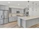 Modern kitchen featuring stainless steel appliances, a large island, and ample cabinet space at 534 Four Seasons Blvd, Summerville, SC 29486