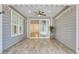 Enclosed patio area with wood-look tile floors, recessed lighting, and a ceiling fan, perfect for relaxing outdoors at 534 Four Seasons Blvd, Summerville, SC 29486
