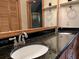 Bathroom with double sink vanity and black granite countertop, ample mirror space and warm lighting at 5354 Ceva Dr, Hollywood, SC 29449