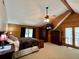 A spacious bedroom featuring wood walls, carpeted floors, and ceiling fan at 5354 Ceva Dr, Hollywood, SC 29449