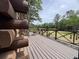 A spacious wooden deck with railing overlooks the picturesque backyard scenery at 5354 Ceva Dr, Hollywood, SC 29449
