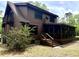 Inviting two-story home featuring a screened-in porch and a charming log cabin exterior at 5354 Ceva Dr, Hollywood, SC 29449