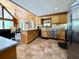 Kitchen with island, breakfast bar, stainless appliances, and tile floors at 5354 Ceva Dr, Hollywood, SC 29449