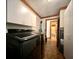 Modern laundry room with new washer and dryer, storage cabinets, and hardwood floors at 5354 Ceva Dr, Hollywood, SC 29449