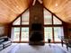 Living room with a stone fireplace, wood paneled walls, and natural light at 5354 Ceva Dr, Hollywood, SC 29449