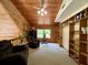 Open loft area with wood paneling, built-in bookshelves, and comfortable seating at 5354 Ceva Dr, Hollywood, SC 29449