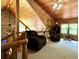 Loft featuring wood paneling and high ceilings over plush seating with backyard views at 5354 Ceva Dr, Hollywood, SC 29449