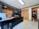 Well-lit home office with wood walls, built-in shelving, and ample desk space at 5354 Ceva Dr, Hollywood, SC 29449