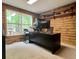 Bright office space with natural wood walls, a large window with backyard views, and shelving at 5354 Ceva Dr, Hollywood, SC 29449
