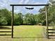 Inviting property entrance with a decorative gate, leading to a home surrounded by nature at 5354 Ceva Dr, Hollywood, SC 29449