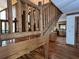 Staircase with wood railing leading to open-concept kitchen at 5354 Ceva Dr, Hollywood, SC 29449