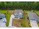 A charming two-story home with double porches, mature landscaping, and a private backyard nestled against a serene wooded area at 5497 Alpine Dr, Summerville, SC 29483