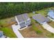 A charming two-story home boasts a double porch, mature landscaping, and a private backyard nestled against a serene wooded area at 5497 Alpine Dr, Summerville, SC 29483