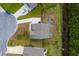 Backyard view featuring an outdoor fire pit, wooden fence, and proximity to a small stream surrounded by a lush green area at 5497 Alpine Dr, Summerville, SC 29483