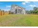 Spacious backyard with a screened-in porch and patio area, perfect for outdoor entertaining at 5497 Alpine Dr, Summerville, SC 29483