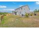 Large backyard with well-maintained lawn, patio seating, and mature trees, offering a private outdoor space at 5497 Alpine Dr, Summerville, SC 29483
