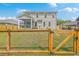 Fully fenced backyard with lush green grass, a patio area, and a view of the home's exterior at 5497 Alpine Dr, Summerville, SC 29483
