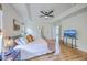 Bright bedroom featuring a ceiling fan, wood floors, television and access to the Primary bath at 5497 Alpine Dr, Summerville, SC 29483