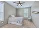 This cozy bedroom offers neutral tones, carpet floors, ceiling fan, and natural light at 5497 Alpine Dr, Summerville, SC 29483