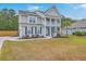 Charming two-story home with a double porch, driveway and mature landscaping at 5497 Alpine Dr, Summerville, SC 29483