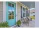 Cozy front porch featuring comfortable wicker seating and a welcoming turquoise door at 5497 Alpine Dr, Summerville, SC 29483
