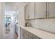 Bright kitchen features shaker cabinets, subway tile backsplash, and a quartz countertop at 5497 Alpine Dr, Summerville, SC 29483