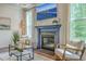 Cozy living room showcasing a fireplace, large windows, and modern decor at 5497 Alpine Dr, Summerville, SC 29483