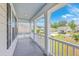 Covered porch with white railings, with a view of the surrounding neighborhood at 5497 Alpine Dr, Summerville, SC 29483