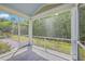 Screened-in porch with views of the landscaped backyard, and seating area with a fire pit at 5497 Alpine Dr, Summerville, SC 29483