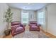 Cozy sitting area with two leather chairs, accent rug, a plant, and natural light from two windows at 5497 Alpine Dr, Summerville, SC 29483